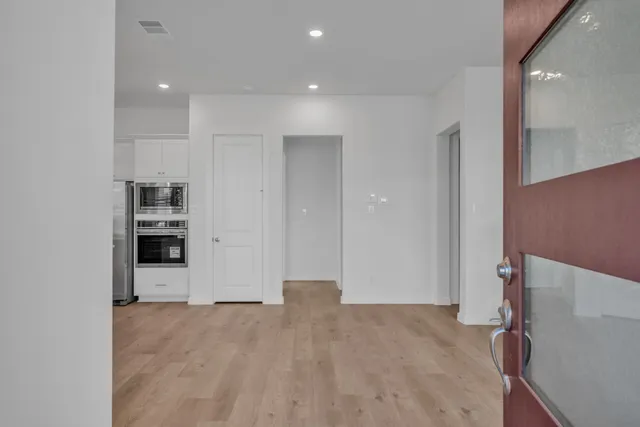 a view of a kitchen with refrigerator and more cabinets