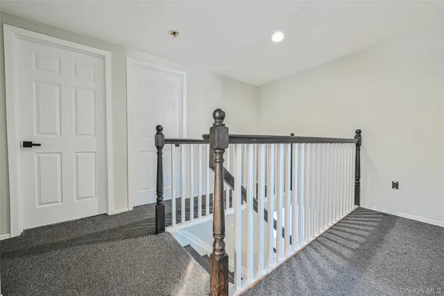 a view of a hallway with a staircase