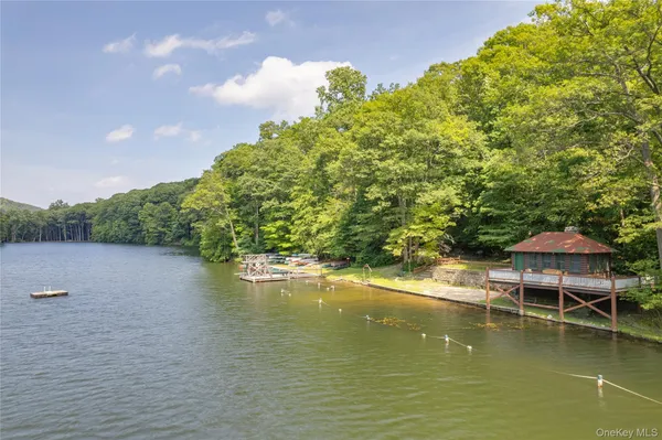 a view of a lake with couches and wooden floor
