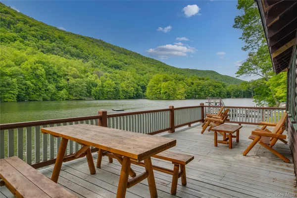 a view of a lake with a bench and trees