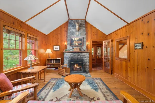 a living room with fireplace furniture and a floor to ceiling window