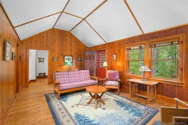 a living room with furniture and a floor to ceiling window
