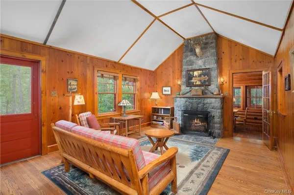 a living room with furniture a fireplace and wooden floor