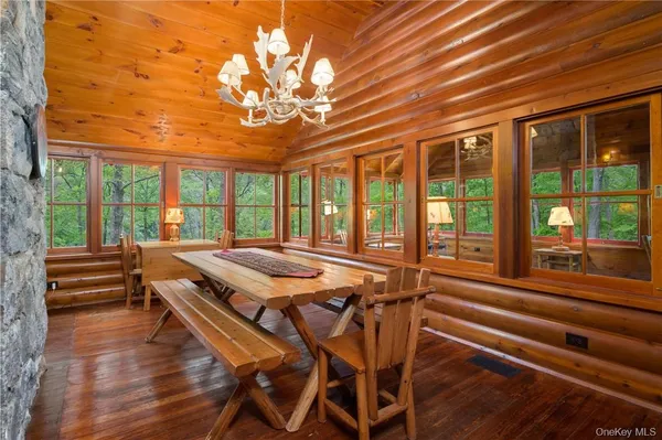 a view of a dining room with furniture wooden floor and chandelier