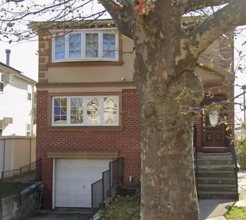 a front view of a house with plants