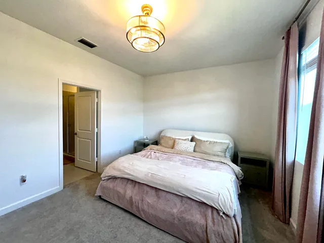 a bedroom with a bed and a chair