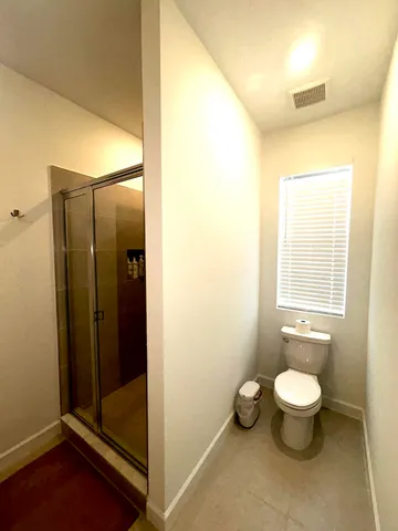 an empty room with closet and windows