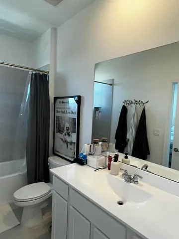 a bathroom with a sink a toilet a tub and shower