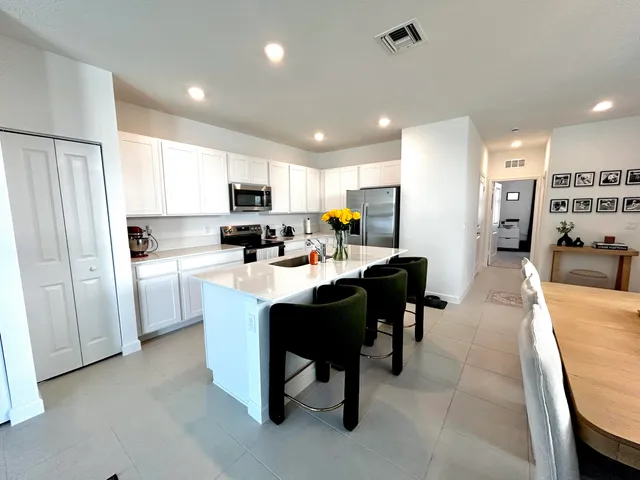 a kitchen with a sink cabinets and window