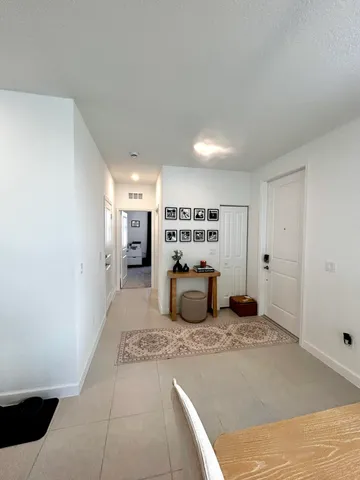 a large bedroom with a bed and a view of living room