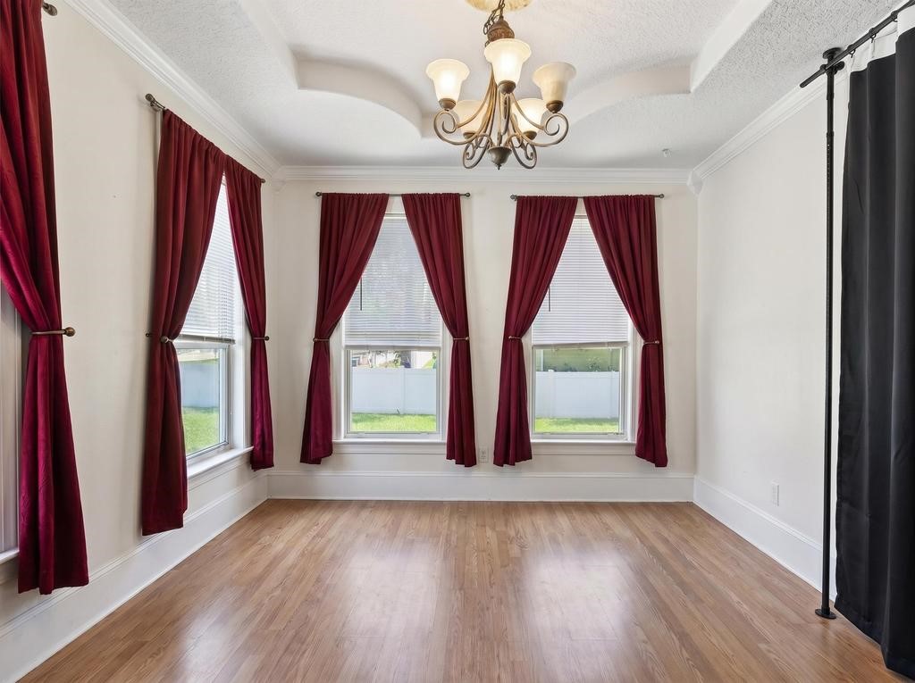 45107 Booth Street Callahan, FL 32011 - Photo 14 of 68 a view of an empty room with wooden floor and windows