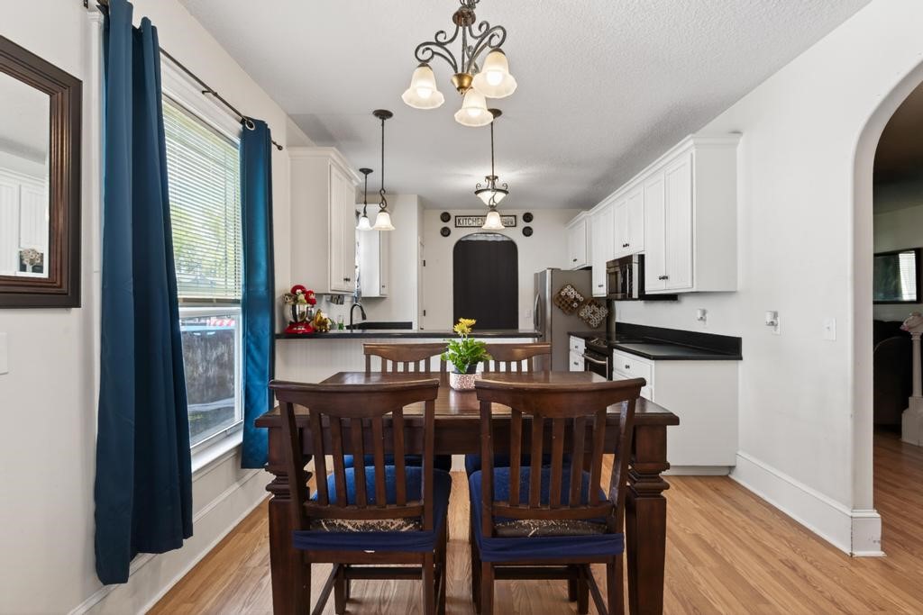 45107 Booth Street Callahan, FL 32011 - Photo 23 of 68 a view of a dining room with furniture a chandelier and wooden floor