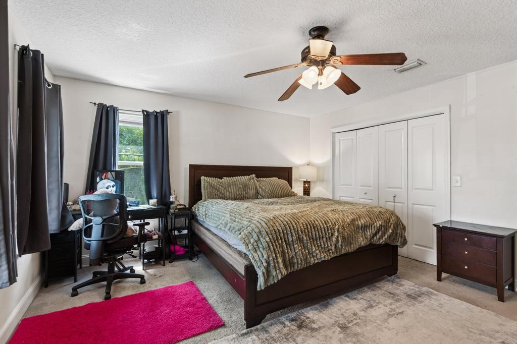45107 Booth Street Callahan, FL 32011 - Photo 38 of 68 a bedroom with a bed gym equipment and a window