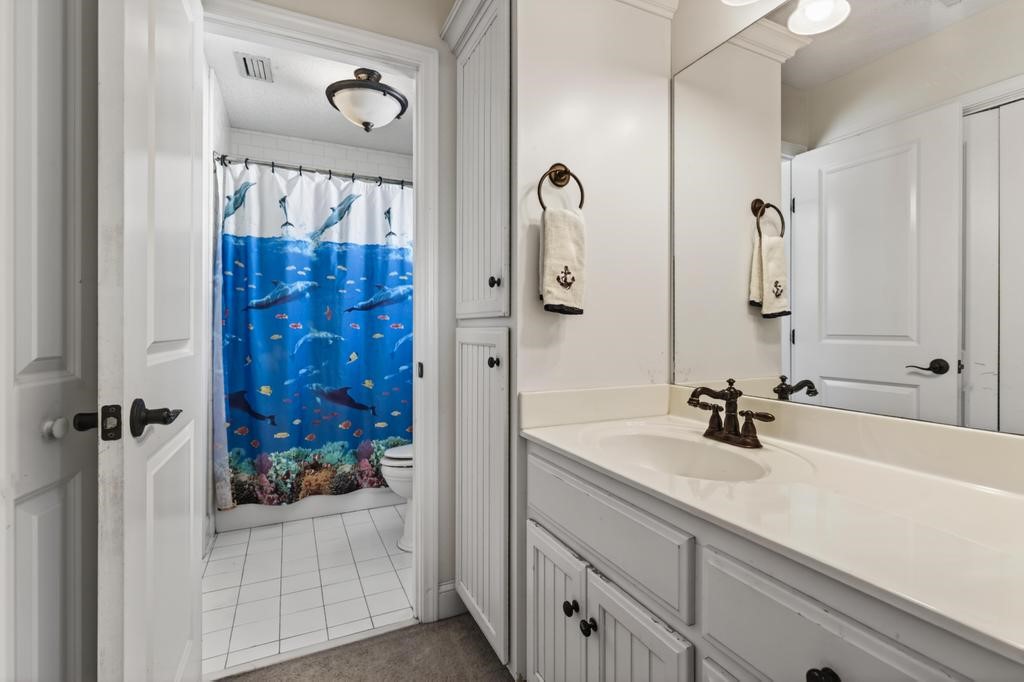 45107 Booth Street Callahan, FL 32011 - Photo 44 of 68 a bathroom with a sink a mirror a vanity and shower