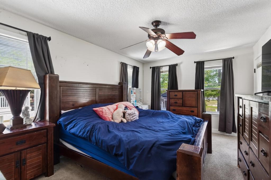 45107 Booth Street Callahan, FL 32011 - Photo 45 of 68 a bedroom with a bed a dresser and window