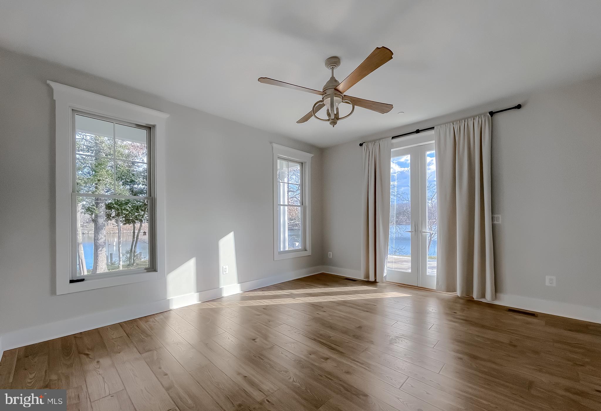 45093 Smiths Nursery Road Hollywood, MD 20636 - Photo 26 of 79 a view of an empty room with wooden floor and a window