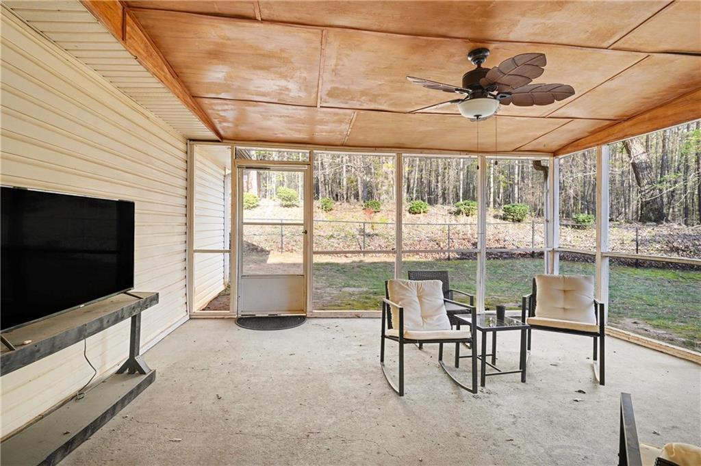 570 Morgan Court Hampton, GA 30228 - Photo 27 of 31 a living room with fireplace furniture and a flat screen tv