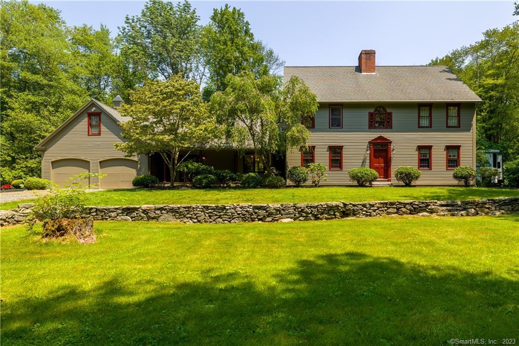 a front view of house with yard and green space