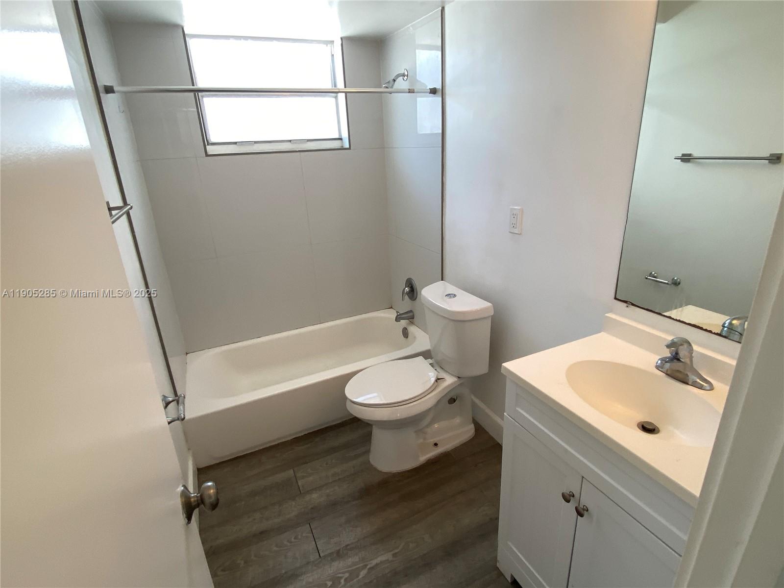 9025 Harding Avenue, Unit 1 Surfside, FL 33154 - Photo 19 of 25 a bathroom with a sink toilet and shower