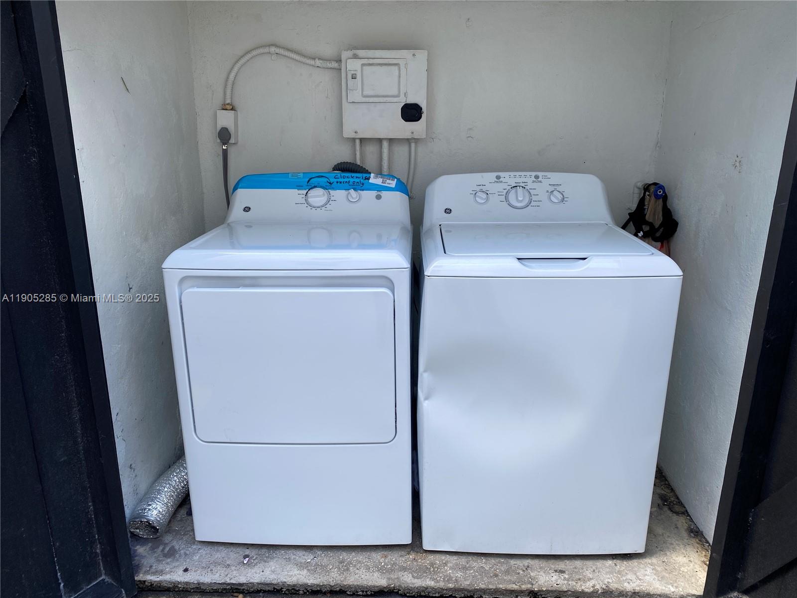 9025 Harding Avenue, Unit 1 Surfside, FL 33154 - Photo 20 of 25 a utility room with dryer and washer