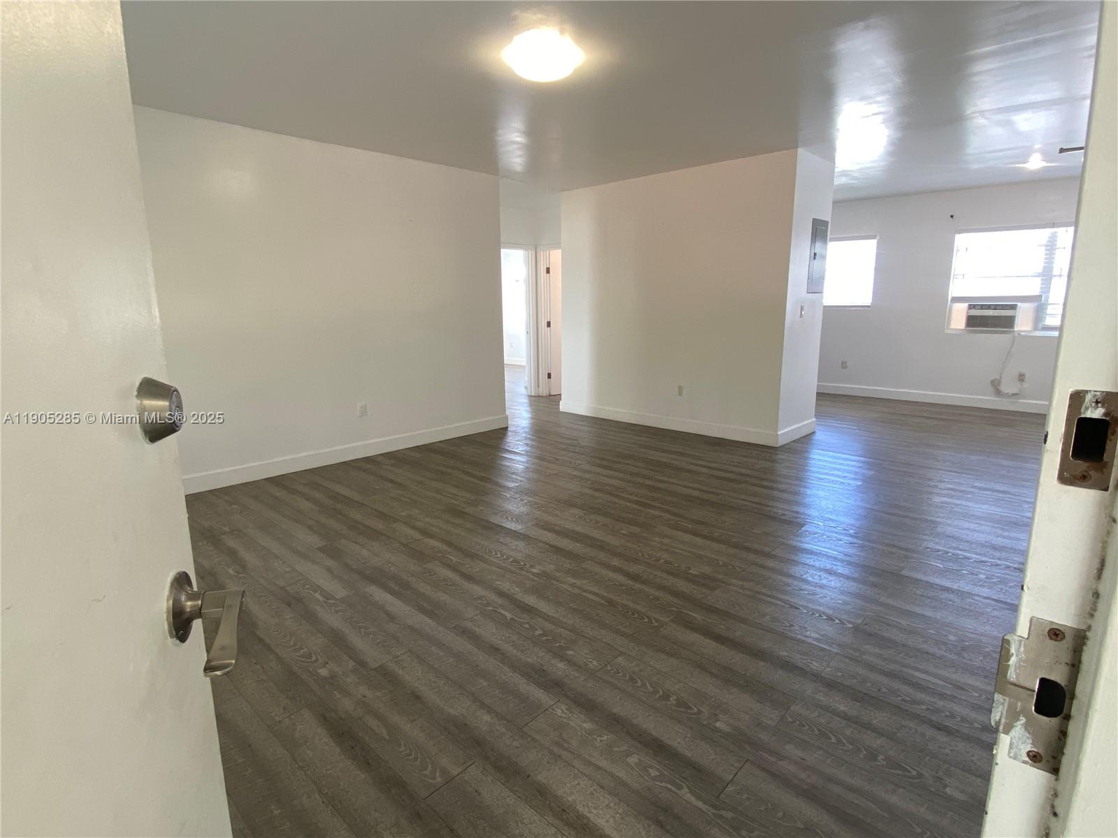 9025 Harding Avenue, Unit 1 Surfside, FL 33154 - Photo 5 of 25 a view of a hallway with wooden floor