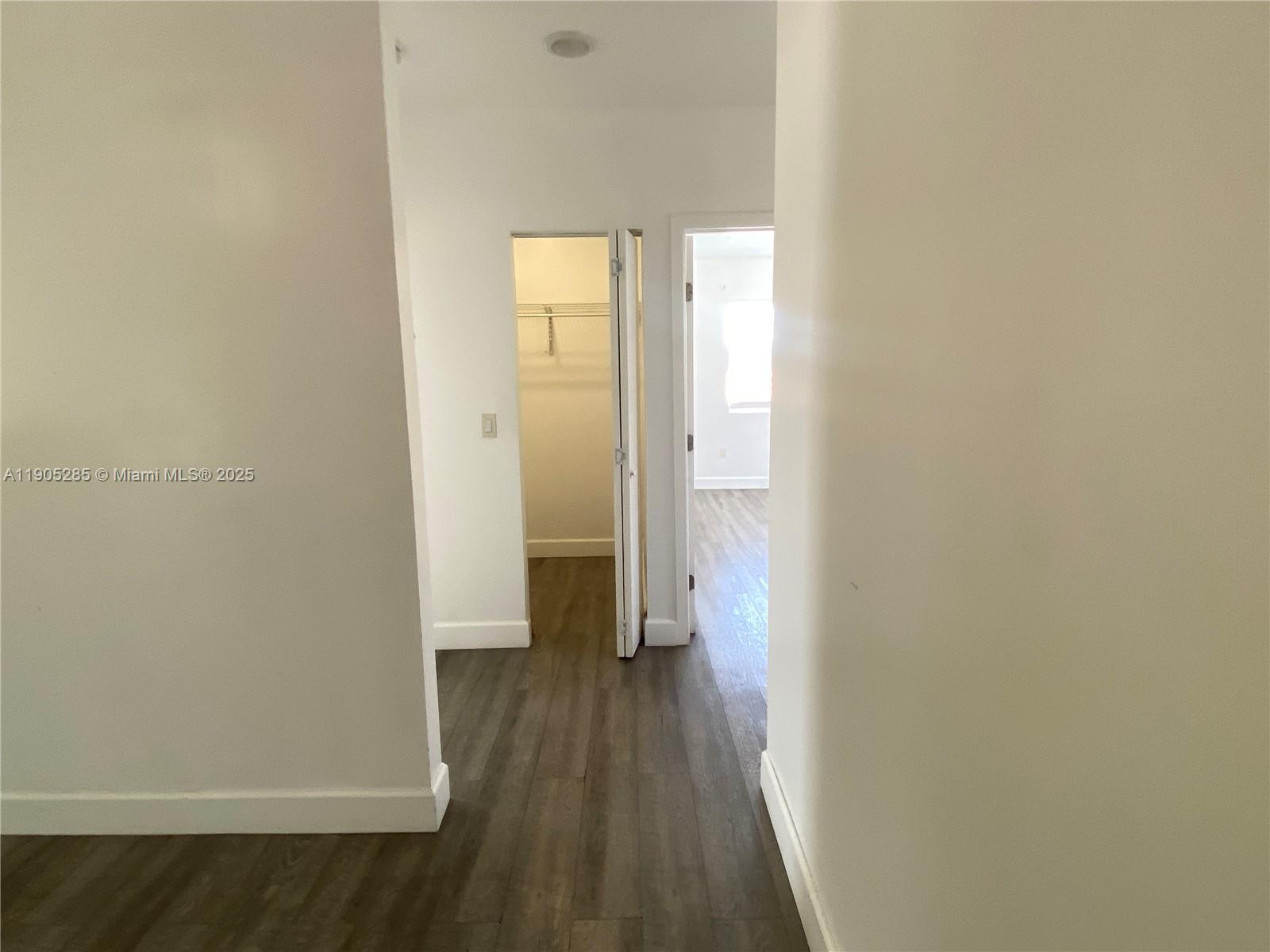 9025 Harding Avenue, Unit 1 Surfside, FL 33154 - Photo 9 of 25 a view of a hallway with wooden floor