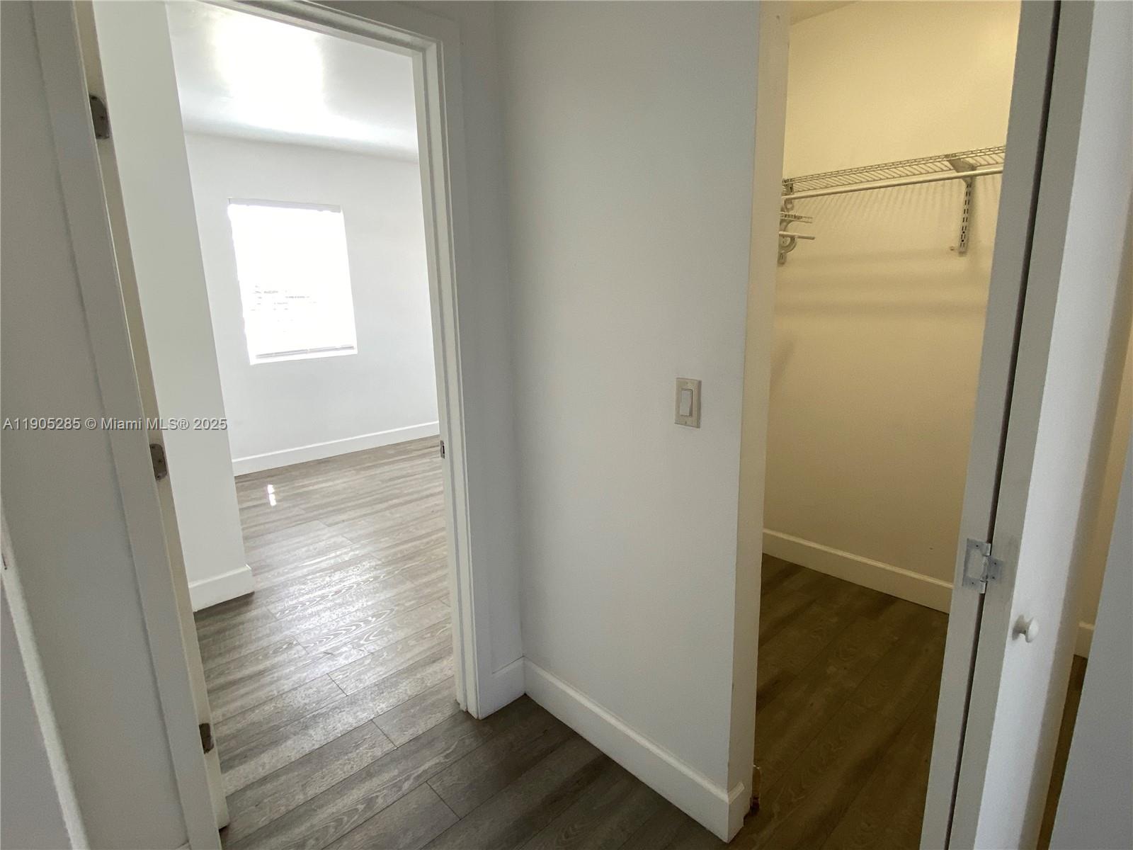 9025 Harding Avenue, Unit 1 Surfside, FL 33154 - Photo 10 of 25 a view of a hallway with wooden floor