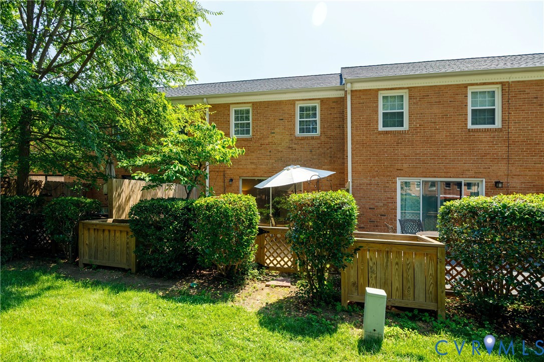 9129 Derbyshire Road, Unit E Henrico, VA 23229 - Photo 31 of 36 Brick exterior with multiple windows and sliding g