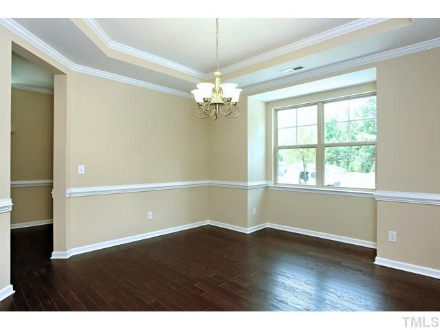2426 Pilsley Road Apex, NC 27539 - Photo 4 of 25 a view of a room with wooden floor and chandelier