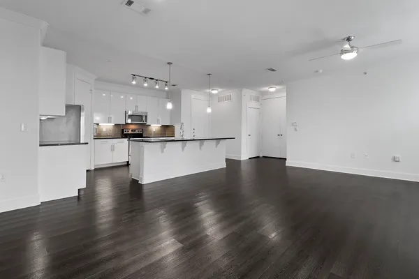 a view of a kitchen with a sink and microwave
