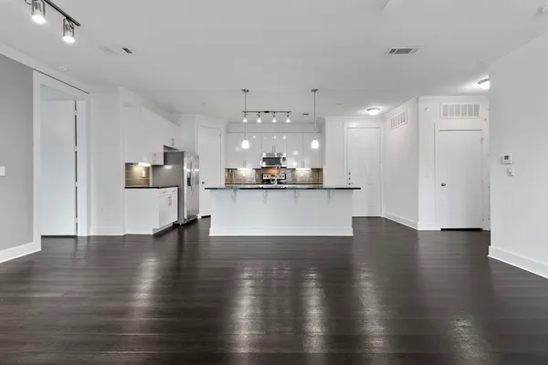 a view of a kitchen with stove and wooden floor