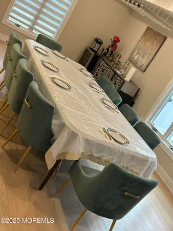 a dining room with furniture and wooden floor