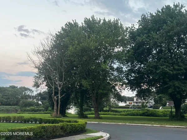 a roof deck with table and chairs a barbeque and wooden fence
