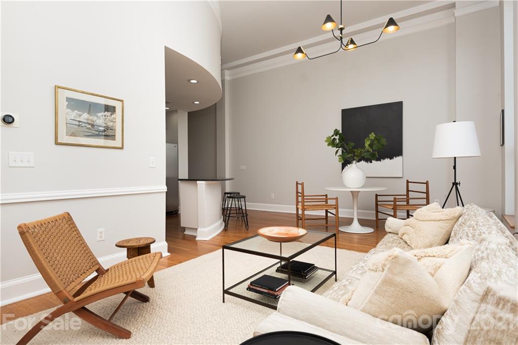 127 North Tryon Street, Unit 416 Charlotte, NC 28246 - Photo 11 of 24 a living room with furniture and a flat screen tv