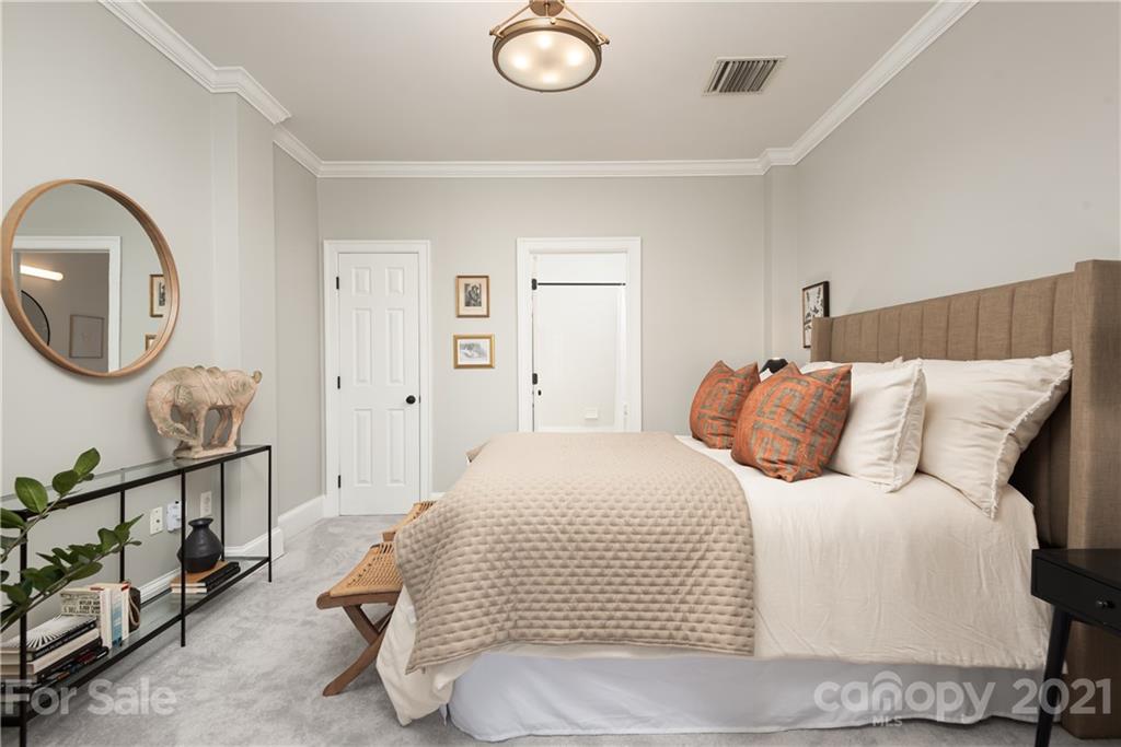 127 North Tryon Street, Unit 416 Charlotte, NC 28246 - Photo 15 of 24 a bedroom with a bed and a dresser