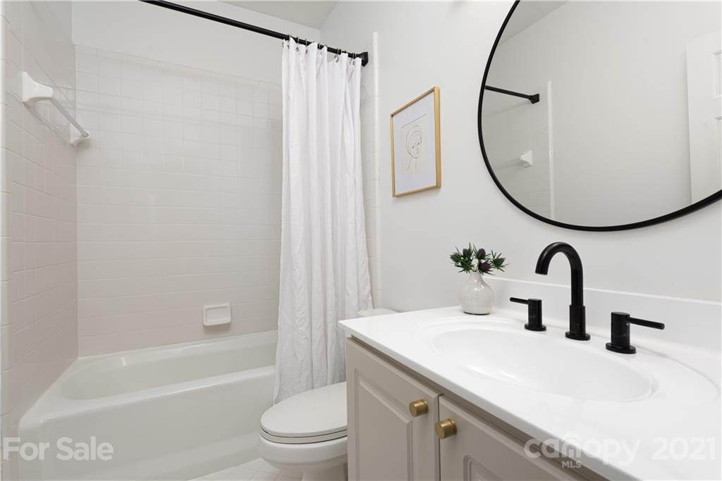 127 North Tryon Street, Unit 416 Charlotte, NC 28246 - Photo 17 of 24 a bathroom with a sink mirror toilet and bathtub