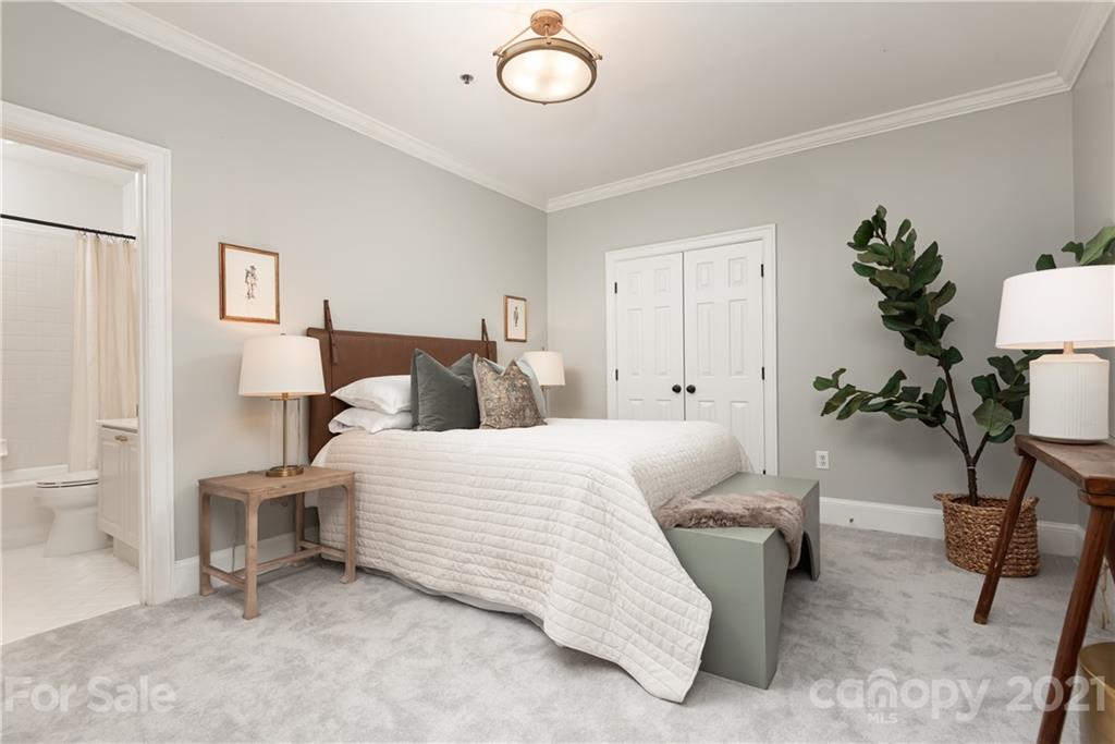 127 North Tryon Street, Unit 416 Charlotte, NC 28246 - Photo 18 of 24 a bedroom with bed and a table