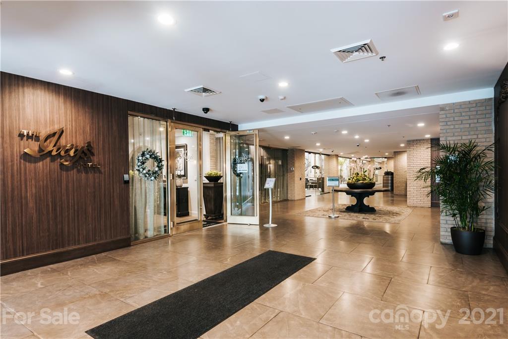 127 North Tryon Street, Unit 416 Charlotte, NC 28246 - Photo 24 of 24 a lobby with furniture and a large window