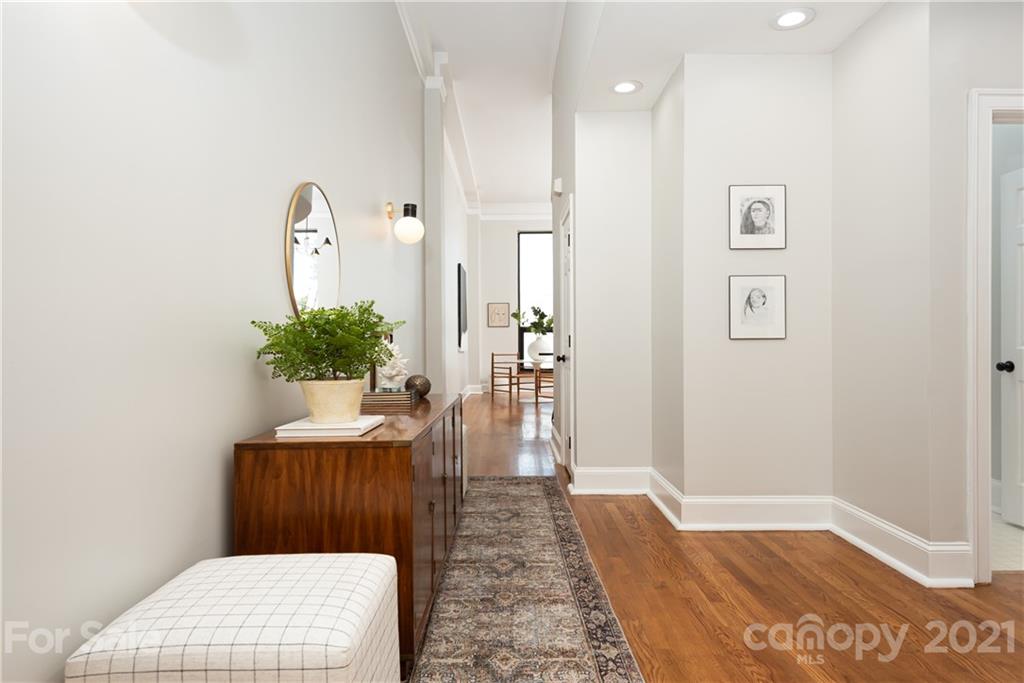 127 North Tryon Street, Unit 416 Charlotte, NC 28246 - Photo 4 of 24 a view of a hallway with wooden floor and table