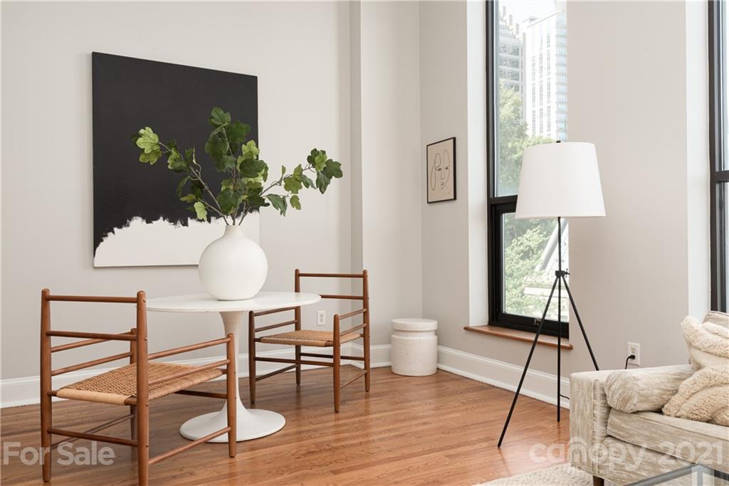 127 North Tryon Street, Unit 416 Charlotte, NC 28246 - Photo 9 of 24 a view of a workspace room with wooden floor table and chair