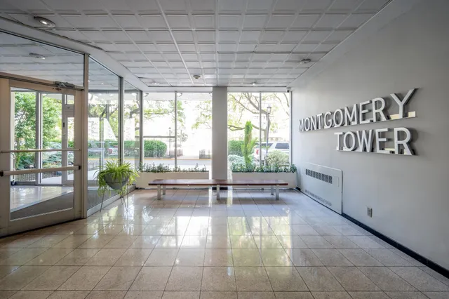 a lobby with furniture and floor to ceiling window