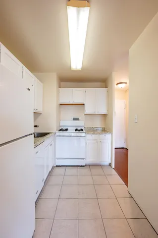 a kitchen with a white cabinets and white appliances