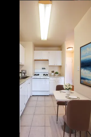 a kitchen with a sink cabinets and window