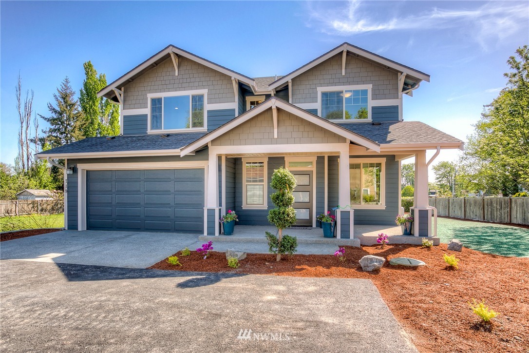 719 Southwest Langston Road Renton, WA 98057 - Photo 1 of 25 a front view of a house with patio