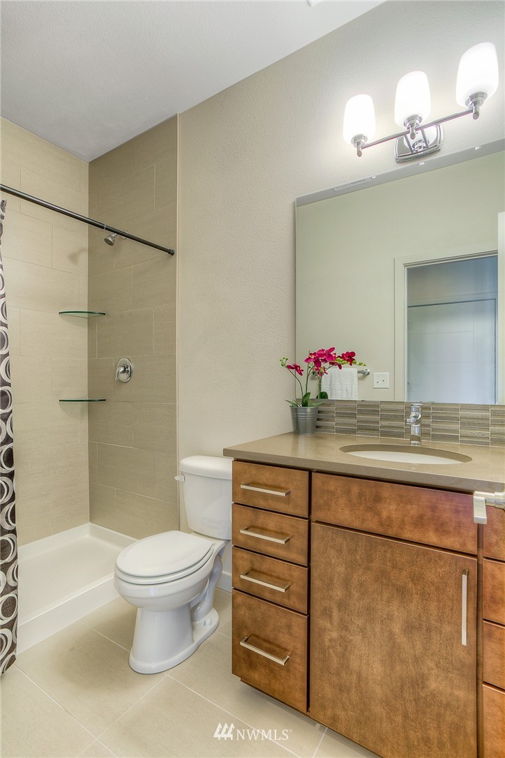 719 Southwest Langston Road Renton, WA 98057 - Photo 12 of 25 a bathroom with a sink toilet and shower