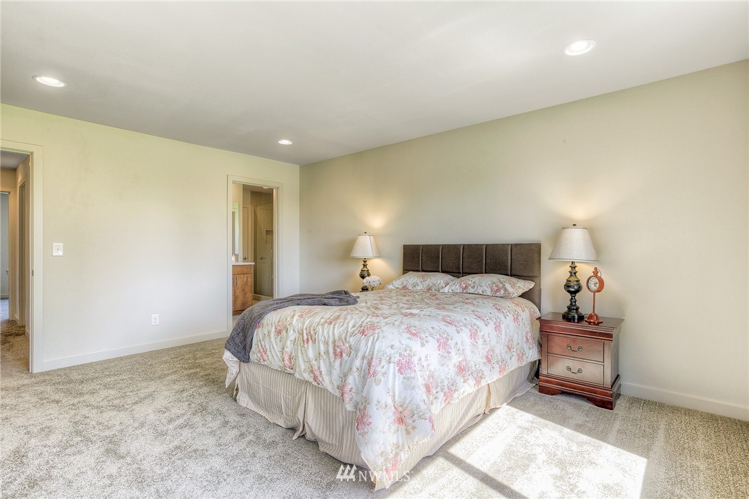 719 Southwest Langston Road Renton, WA 98057 - Photo 15 of 25 a bedroom with a bed and a night stand