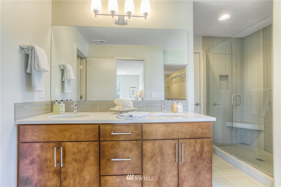 719 Southwest Langston Road Renton, WA 98057 - Photo 16 of 25 a bathroom with a granite countertop sink a mirror and shower