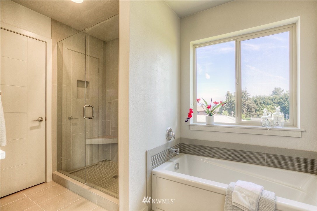 719 Southwest Langston Road Renton, WA 98057 - Photo 17 of 25 a bathroom with a bathtub and a shower