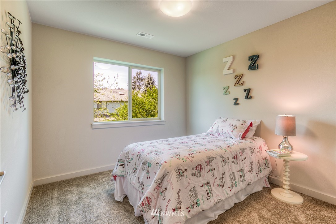 719 Southwest Langston Road Renton, WA 98057 - Photo 19 of 25 a bedroom with a bed and a window