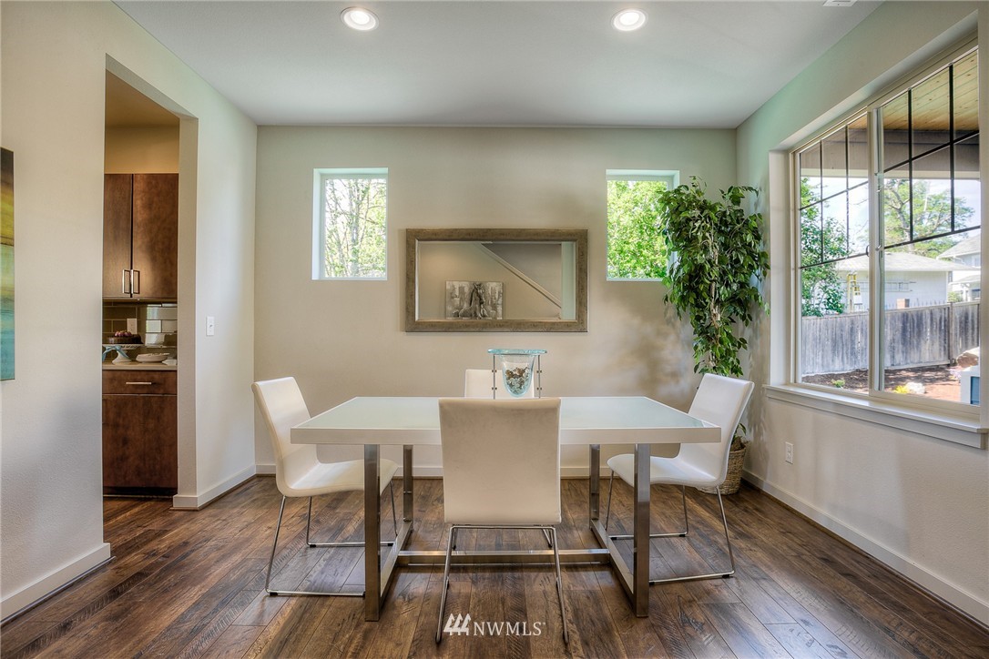 719 Southwest Langston Road Renton, WA 98057 - Photo 3 of 25 a view of a dining room with furniture and wooden floor